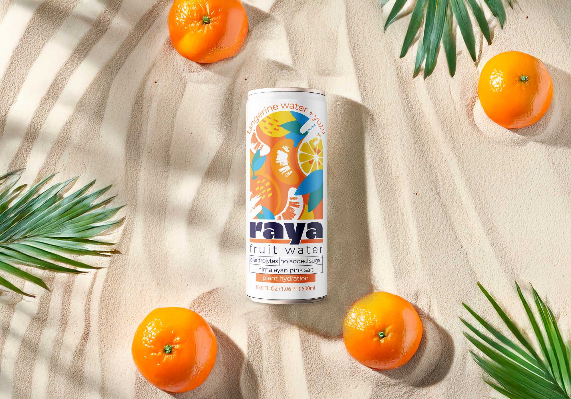 Raya tangerine water + yuzu can on a beach